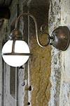 Frosted globe wall lamp in aged patinated brass. Aldo Bernardi. 