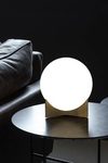 Oscar table lamp with white glass globe and satin brass base. Terzani. 