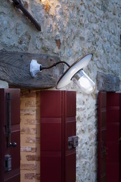 Patina brass and porcelain outdoor wall light with clear glass
