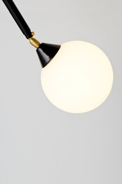Suspension on black metal rod and white ball in opal glass