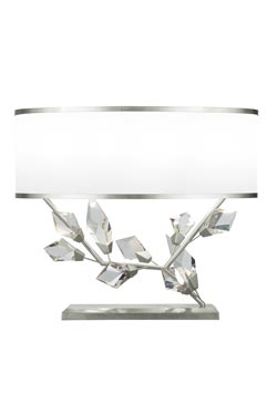 Table lamp with white shade and silver finish base, facing right