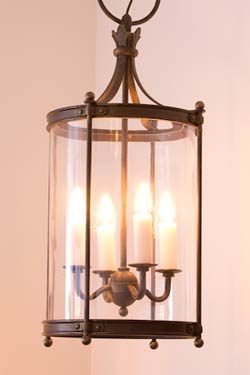 Suspension en fer forgé forme cylindrique quatre lumières